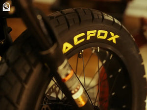 Close-up view of the front fat tire on the Macfox e-bike