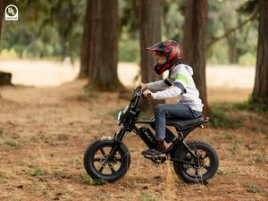 Boy riding a Macfox M16 teen e-bike in the woods
