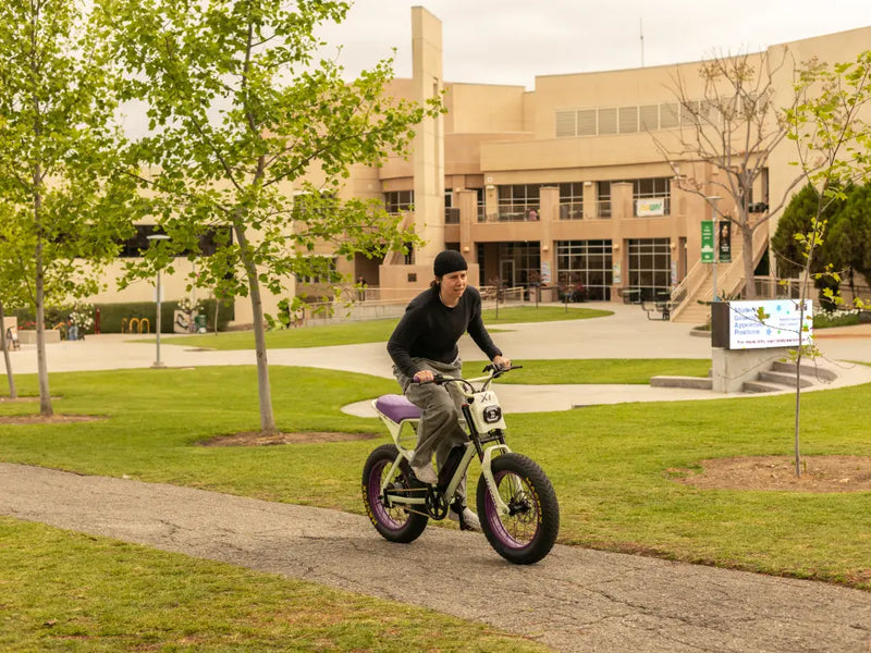 Person commuting on a Macfox X1S eBike along a campus walkway