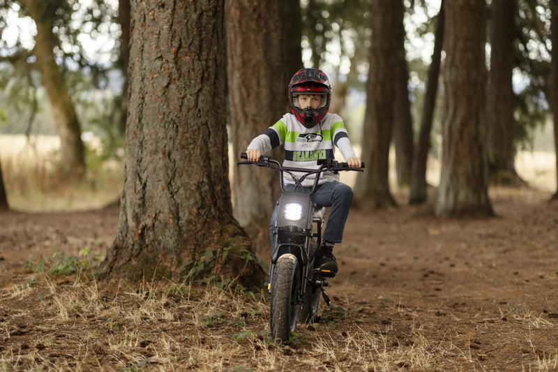 Teen rider practicing balance on a youth electric bike in the woods – Macfox M16 beginner e-bike tricks.
