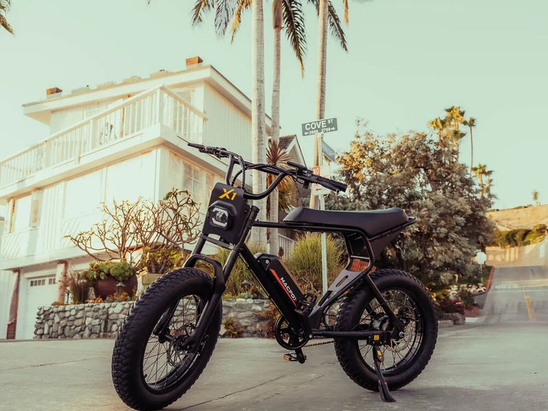 Macfox X1S commuter electric bike parked on a residential street with palm trees