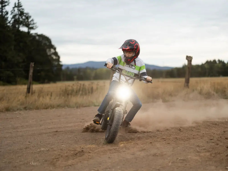 A rider riding a Macfox M16 electric bike on a dirt path