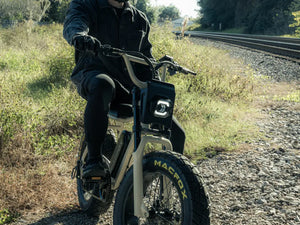 Rider practicing off-road riding on a Macfox X7 fat-tire eBike near a gravel path
