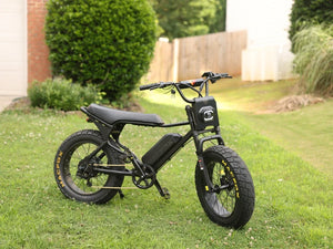 Macfox X7 eBike with its front and rear tires visible, parked on a lawn.