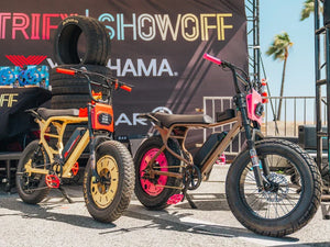 Macfox X7 and X2 electric bikes showcased at an outdoor event, highlighting their fat tires and rugged design