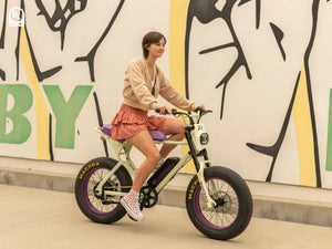 A girl riding a Macfox X1S x Bs.zay electric bicycle on the street.