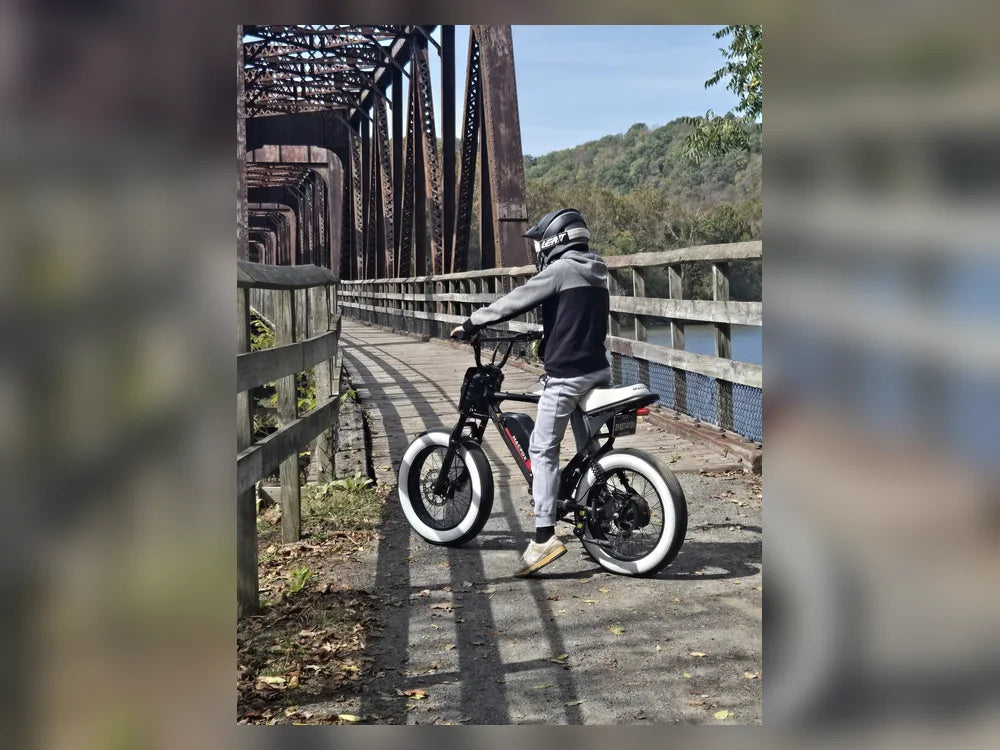 articles/macfox-x7-black-electric-bike-helmeted-rider-bridge-001.webp