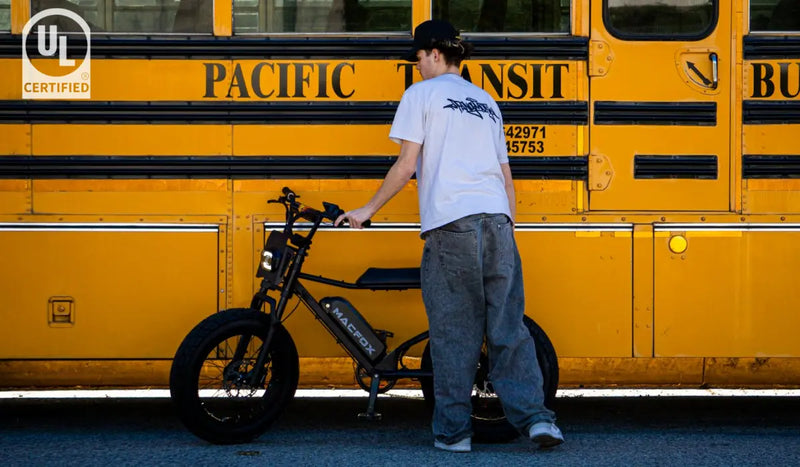 The man is preparing to ride a Macfox X7 electric bicycle.
