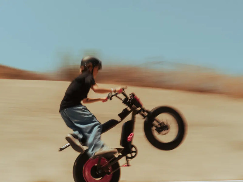 younger rider performing a wheelie on Macfox X7 ebike