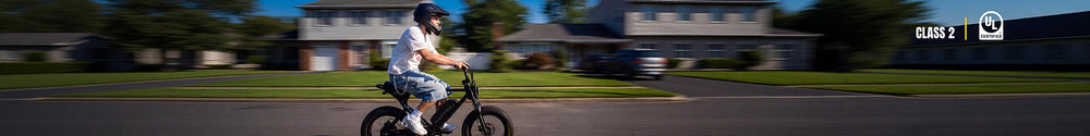 A helmeted rider commutes through a suburban neighborhood on a Macfox X1S commuter eBike.