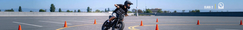 A helmeted rider corners through a cone course on a Macfox  X7 electric bike with throttle.