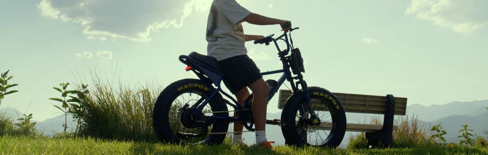 The rider is riding a Macfox X7 moped-style electric bike